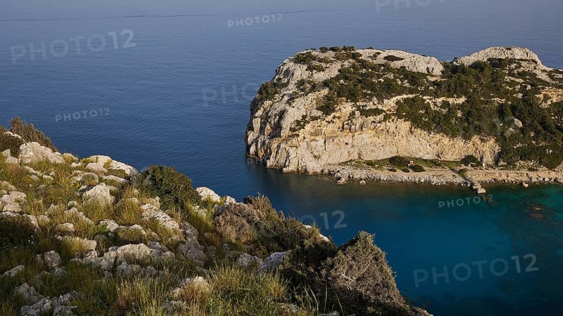 Rocky coastal landscape with green vegetation and calm blue water, Anthony Quinn Bay, Vagies Bay, Rhodes, Dodecanese, Greek Islands, Greece, Europe