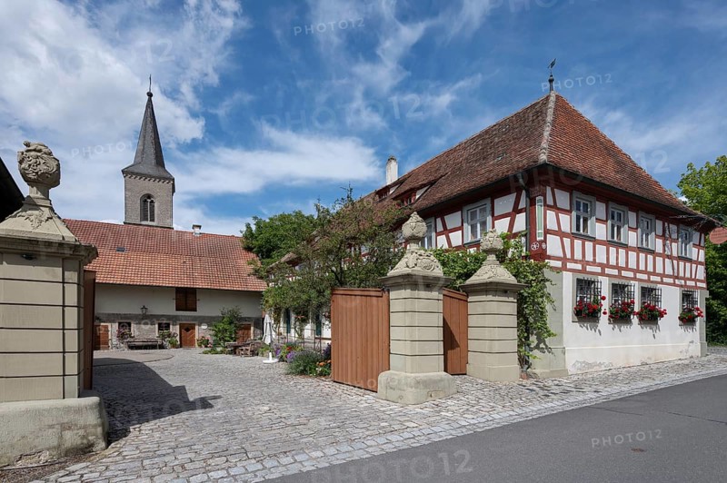 Court gate with vase attachments from 1774, on the right former Ebracher Schultheissenhof from 1778, Hüttenheim 58, Hüttenheim, . Lower Franconia, Bavaria, Germany, Europe