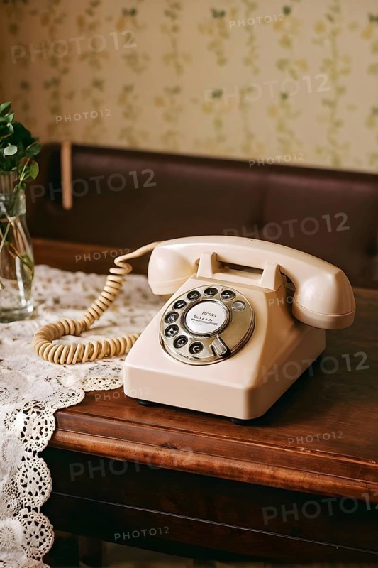 Old rotary phone sitting on a retro floral-patterned tablecloth, AI generated