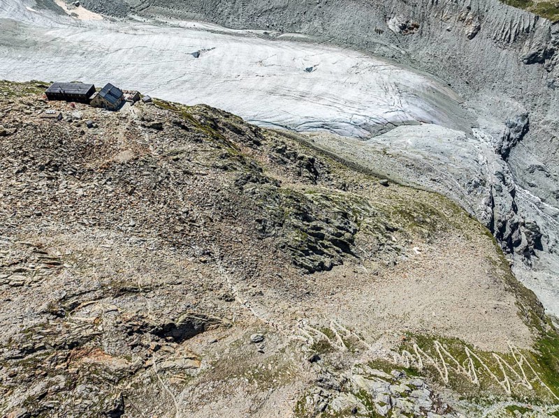Mountain hut Cabane de Moiry, located close to glaciar tongue of the retreating Moiry glacier, hiking trail, aerial view, Valais, Switzerland, Europe