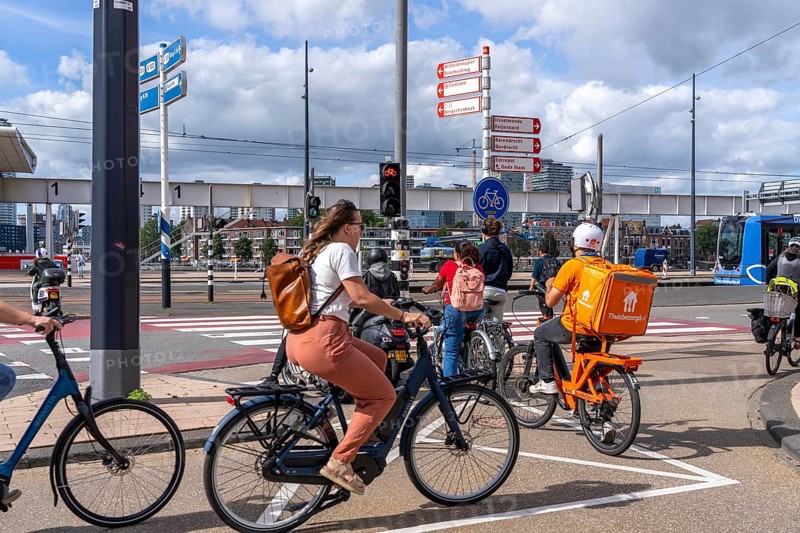 Cyclist, moped rider, waiting at a red traffic light, Feijenoord, in front of the Erasmus Bridge, Rotterdam, Netherlands