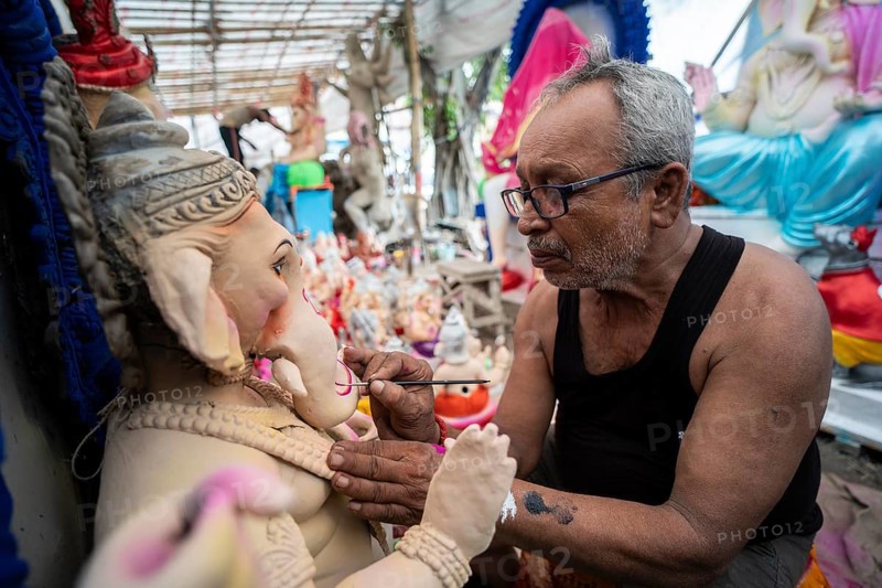 An artisan gives final touches to an idol of the elephant-headed Hindu deity Ganesha at a workshop ahead of the Ganesh Chaturthi festival on September 5, 2024 in Guwahati, Assam, India, Asia