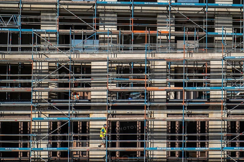 Construction site, at the Cologne Trade Fair Centre, new construction of a high-rise office building, construction cranes, facade of the shell, scaffolding, North Rhine-Westphalia, Germany, Europe