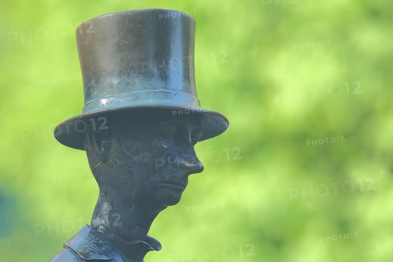 Man with top hat and historical Biedermeier clothing at the Datterich fountain, headgear, hat, bronze, sculpture, detail, face, nose, grey, green, funny, comical, Luisenplatz, Darmstadt, Bergstrasse, Hesse, Germany, Europe