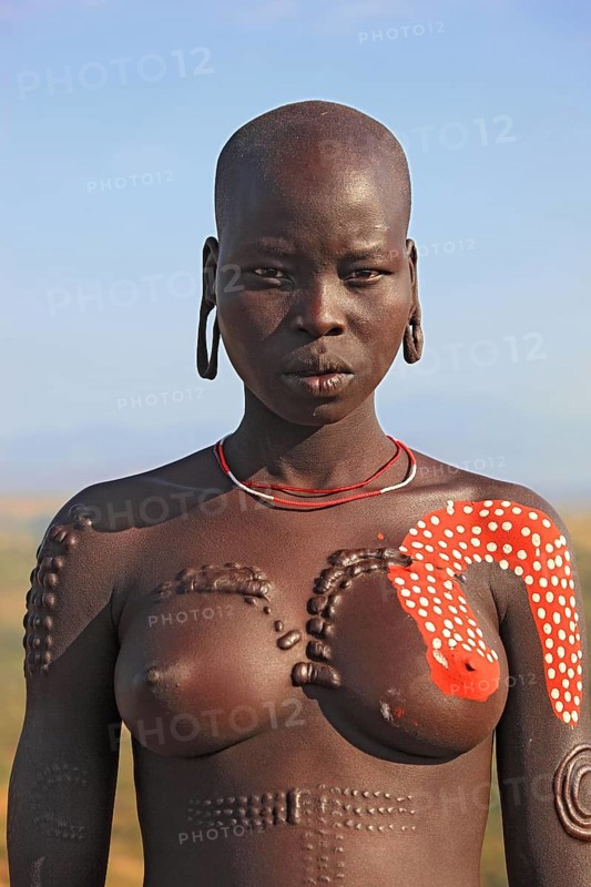 South Ethiopia, in the Maco National Park, woman from the Mursi tribe, Mursi woman with naked upper body and painted skin, Ethiopia, Africa