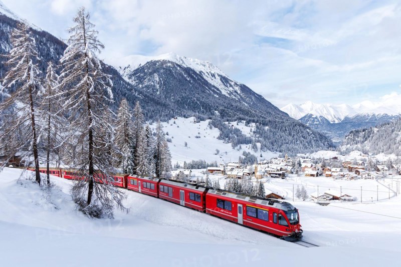 Rhaetian Railway train on the Albula railway Passenger train in the Alps in Bergün, Switzerland, Europe
