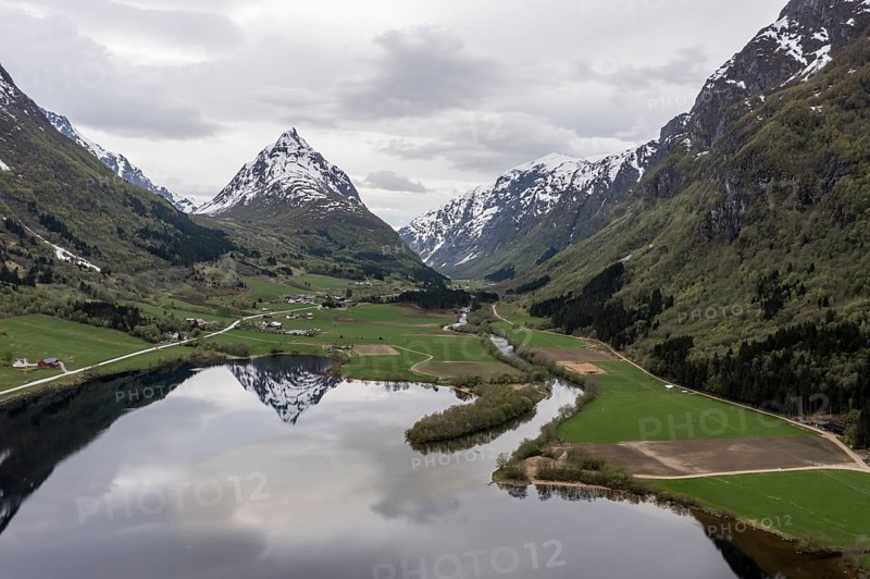 Mountain Eggenipa reflected in lake Bergheimsvatnet, south of Byrkjelo, Norway, Europe