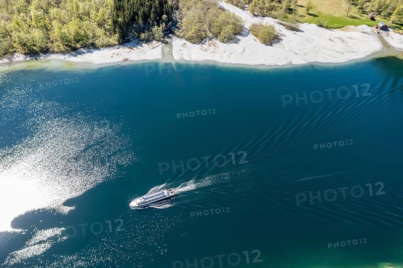 Aerial view of lake Lovatnet (or: Loenvatnet), local cruise ship on its way to Kjenndalstova, valley Lodalen south of village Loen, Norway, Europe