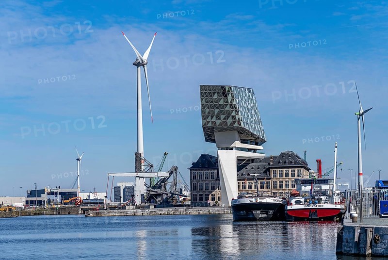 The Antwerp Port Authority building, Havenhuis, former fire brigade barracks in the harbour, renovated and with an attached glass structure in the shape of a ship's hull, administrative headquarters of the Antwerp Port Authority, designed by Zaha Hadid, Antwerp, Flanders, Belgium, Europe