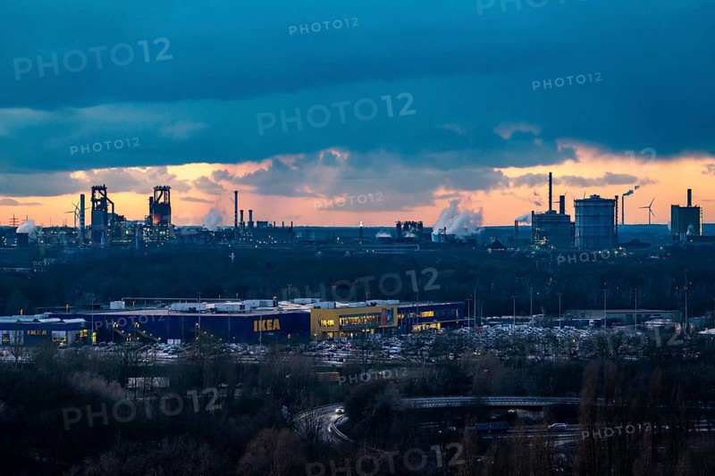 Skyline of the steel location Duisburg, Thyssenkrupp Steel Europe, in Duisburg-Bruckhausen, sunset, industrial scenery, North Rhine-Westphalia, Germany blast furnaces Schwelgern 1 and 2, cooling tower of the coal-fired power plant Walsum, blast furnaces 8 and 9, industrial area, IKEA, furniture store