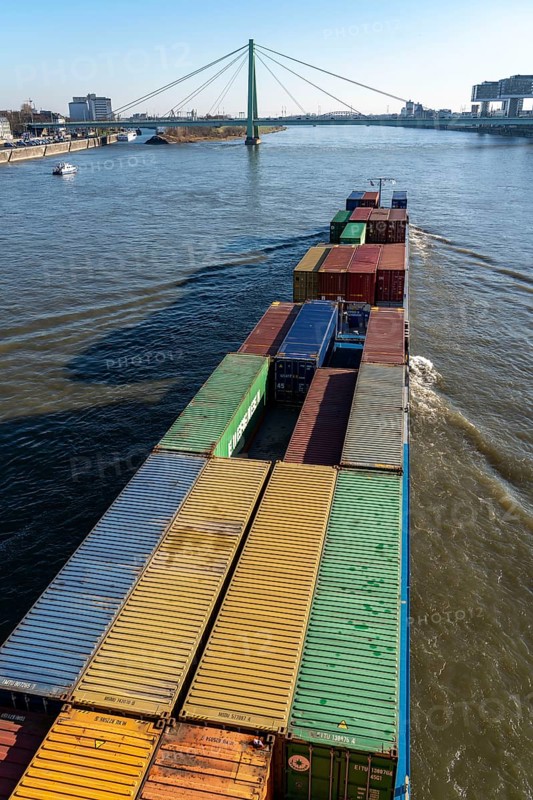 Container cargo ship on the Rhine, heading south, the crane houses in Cologne at the Rheinauenhafen, Cologne-South, residential and office buildings, Severinsbrücke, Cologne, North Rhine-Westphalia, Germany, Europe