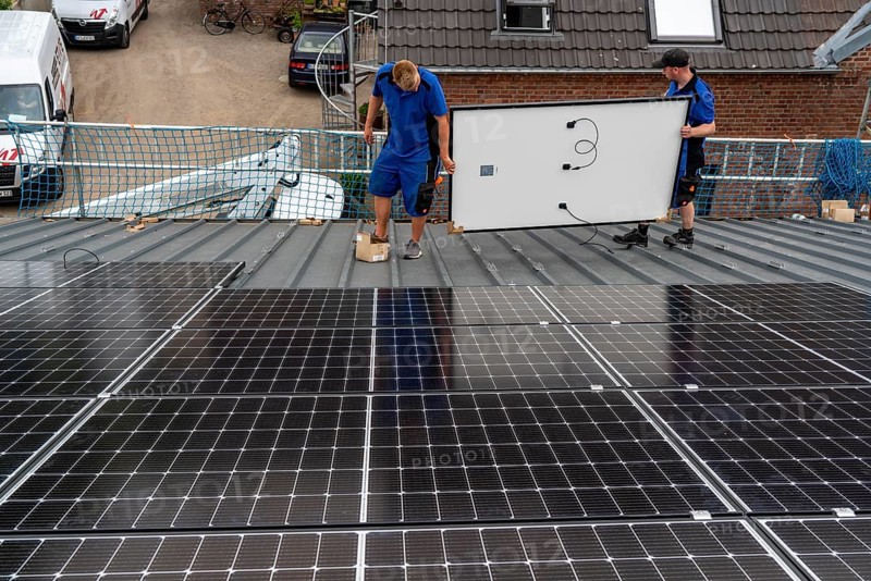 Installation of solar modules on the roof of a barn on a farm, over 240 photovoltaic modules are installed on the roof, North Rhine-Westphalia, Germany, Europe