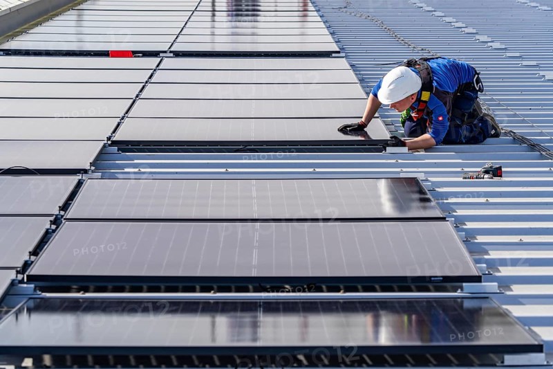 Installation of solar modules on the roof of a commercial enterprise, over 400 photovoltaic modules are installed on the roof, North Rhine-Westphalia, Germany, Europe
