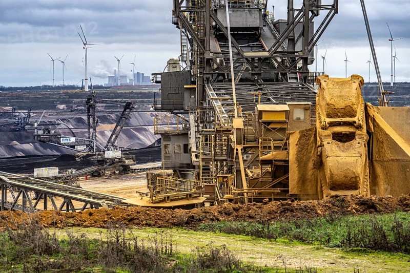 Opencast lignite mine Garzweiler 2, bucket wheel excavator 261 excavating the surface, at the rest of the hamlet of Lützerath, behind excavator 288, mining lignite, Neurath lignite-fired power station, wind farm, Erkelenz, North Rhine-Westphalia, Germany, Europe