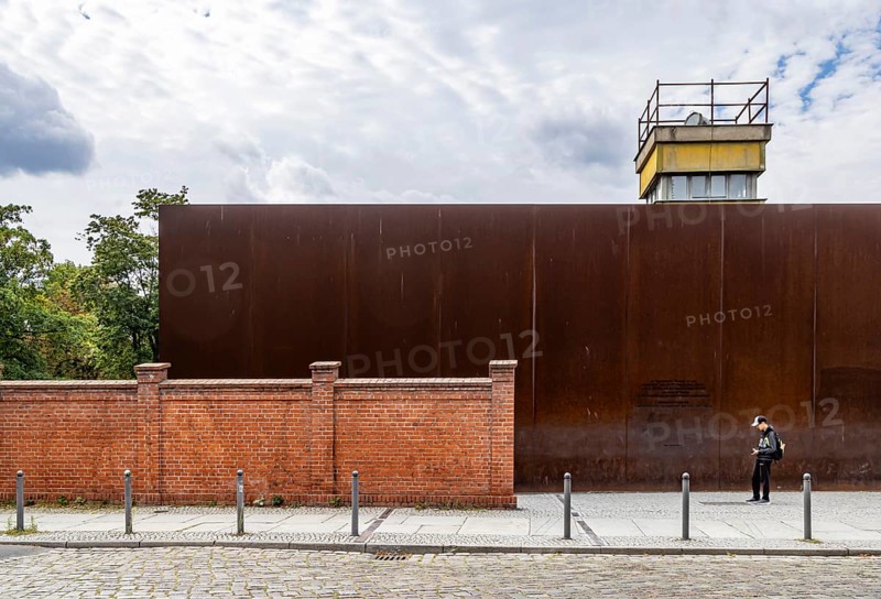 Berlin Wall Memorial, sight and reminder of the division by the Berlin Wall and of the fatalities at the border. Original preserved border strip with watchtower on Bernauer Strasse, Berlin, Germany, Europe