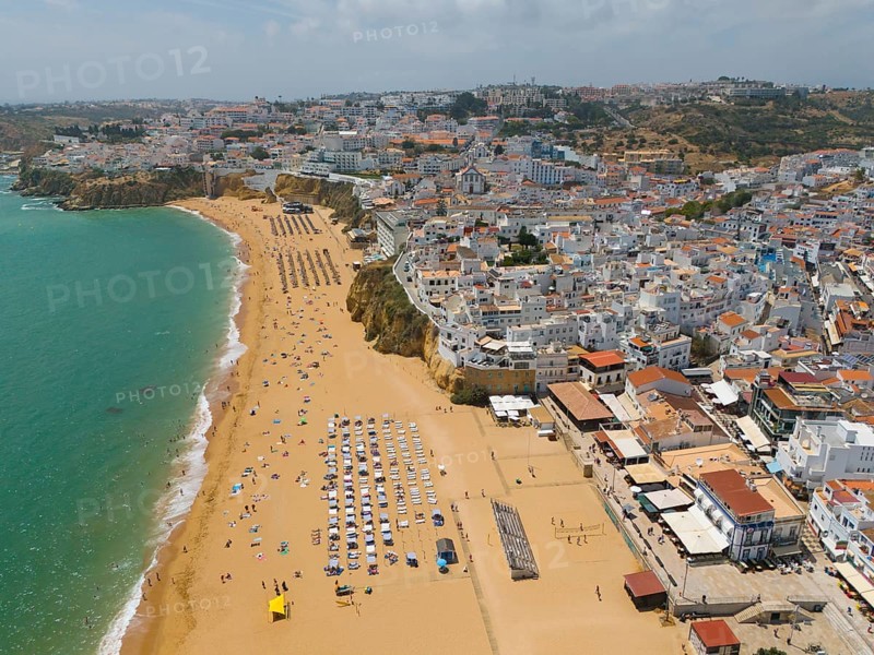 Aerial view of a coastal town with a sandy beach on which numerous parasols and deckchairs can be seen, Albufeira, Faro, Algarve, Portugal, Europe