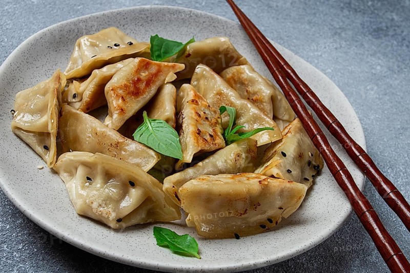 Japanese fried dumplings, gyoza, sesame seeds, top view, no people
