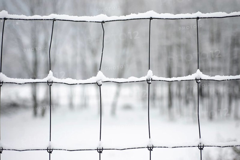 Metal Fence with Snow in a Winter Day in Locarno, Ticino, Switzerland, Europe