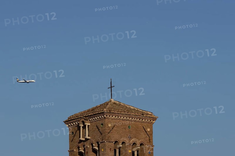 Boeing 737 jet passenger aircraft of Ryanair flying in a blue sky over an ancient city building, Rome, Italy, Europe