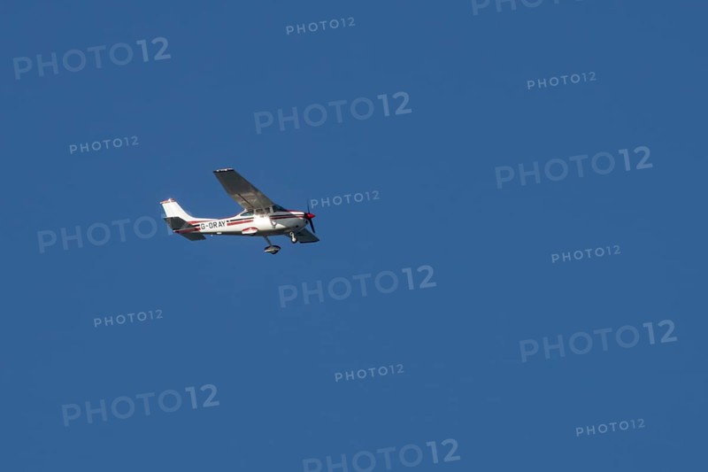 Cessna F182Q Skylane aircraft flying in a blue sky, England, United Kingdom, Europe