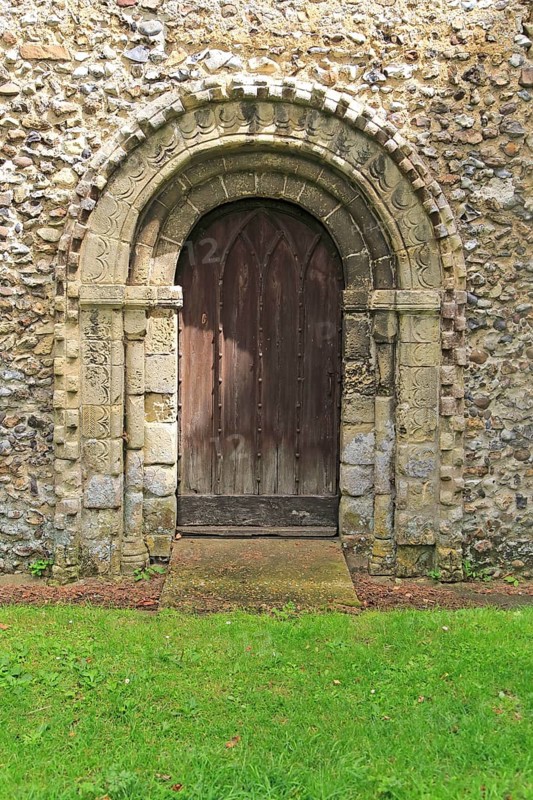 Norman style external doorway entrance, Saint Andrew church, Westhall, Suffolk, England, UK