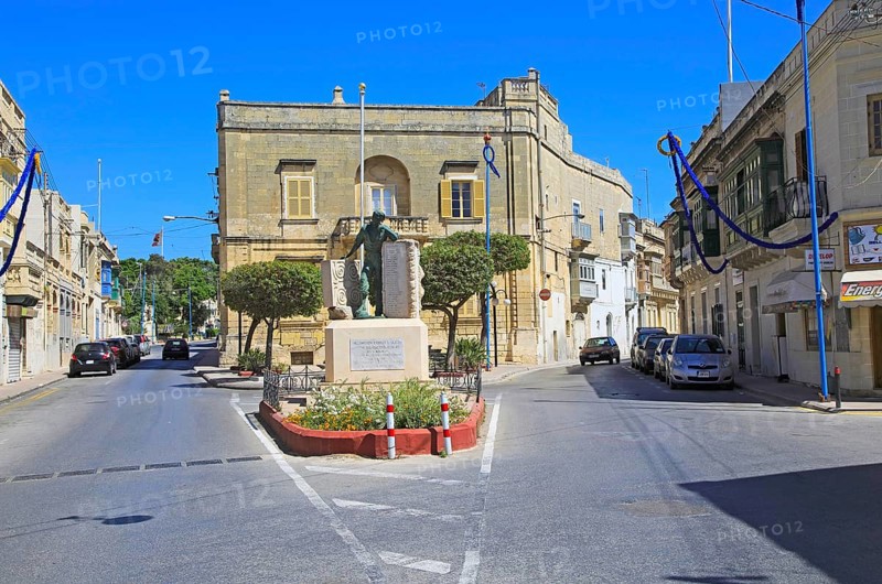 Historic streets in Tarxien area, near Valletta, Malta small square with war memorial sculpture