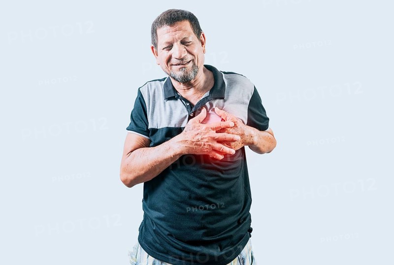 Elderly person with heart problems. Senior man with tachycardia touching his chest. Old man with heart pain touching chest isolated