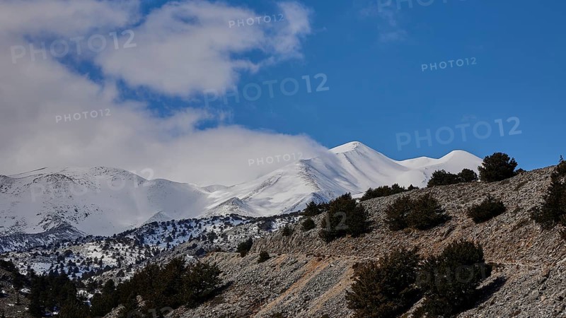 Unpaved road to the Niatos Plateau, Snowy mountains under a blue sky with soft cloud streaks, near Askifou, Sfakia, Lefka Ori, White Mountains, West Crete, Crete, Greece, Europe