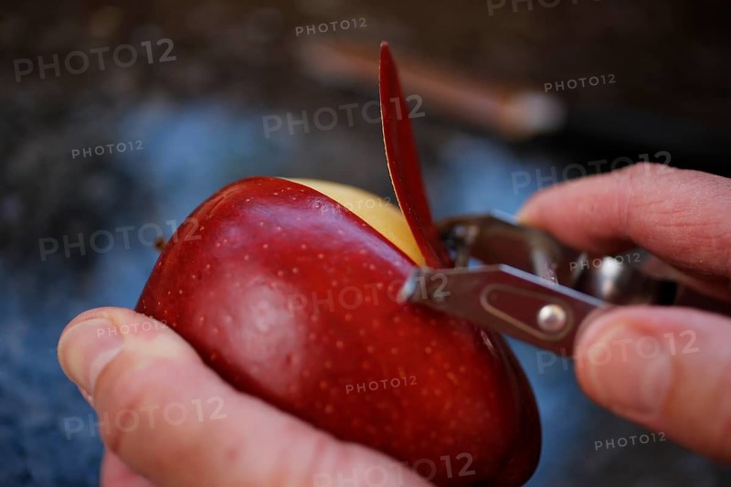 Swabian cuisine, preparation of Ofenschlupfer, apple peeling, sweet main dish or dessert, dessert, typical Swabian, classic, from the oven, paring knife, men's hands, home cooking, traditional cuisine, food photography, studio, Germany, Europe