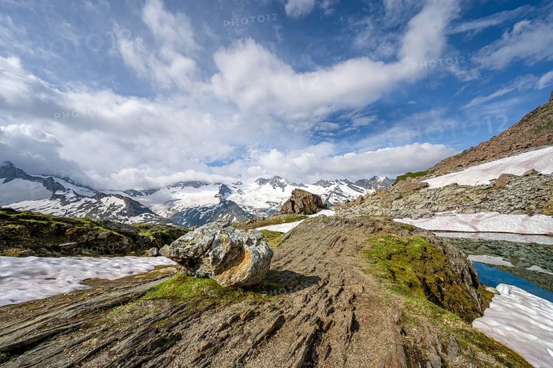 Picturesque mountain landscape at Schwarzsee, mountain peaks with snow and glacier Schwarzensteinkees and Hornkees summit Schwarzenstein and Hornspitzen, Berliner Höhenweg, Zillertal Alps, Tyrol, Austria, Europe