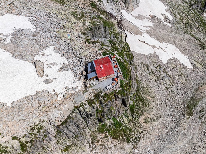Aerial view of mountain hut Cabane de l'A Neuve, located on a steep rock formation, near La Fouly, Val de Ferret, Valais, Switzerland, Europe