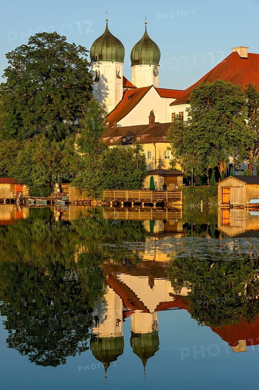 Romanesque Benedictine Abbey Seeon Monastery, monastery church St. Lambert with reflection in the monastery lake, calm smooth water in the evening light at sunset, Seeon-Seebruck, Chiemgau, Upper Bavaria, Bavaria, Germany, Europe