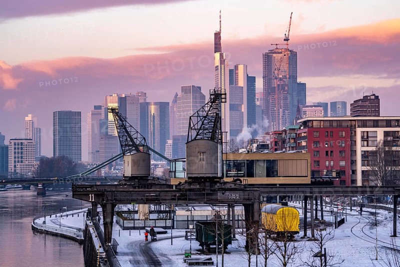The skyline of Frankfurt am Main, skyscrapers of the banking district, historic harbour cranes at the Wesel shipyard, wintry morning, Hesse, Germany, Europe