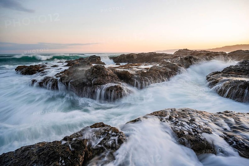 Waves washing over rocks by the sea, long exposure, coastal landscape at sunset, Playa Cocalito, Pacific coast, Nicoya Peninsula, Puntarenas province, Costa Rica, Central America