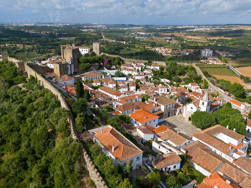 Aerial view of a historic town with red roofs, surrounded by castle walls and embedded in a green landscape, town, castle, Castelo de Óbidos, town wall, Óbidos, Obidos, Oeste, Centro, Estremadura, Portugal, Europe