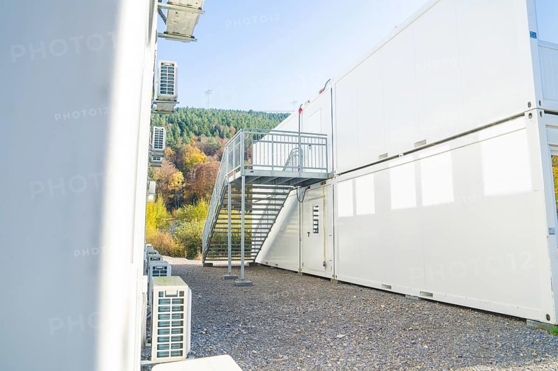 Side view of a container building with air conditioning and metal staircase, refugee accommodation Beermiß, Calmbach, Black Forest, Germany, Europe