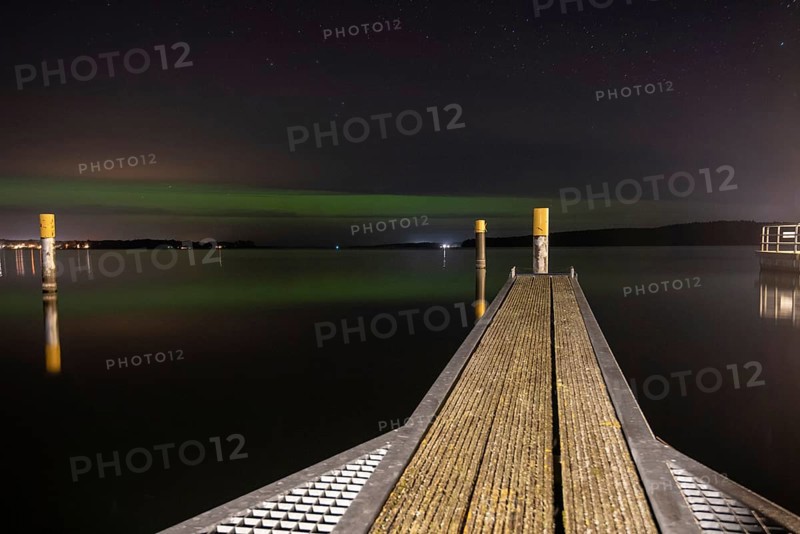 Northern lights (aurora borealis) shine on a starry night over Lake Plau, Ganzlin, Mecklenburg-Vorpommern, Germany, Europe