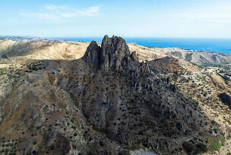 Mountains and Olive groves around Ghost Town from a drone, Pentedattilo Village, Calabria, Italy, Europe