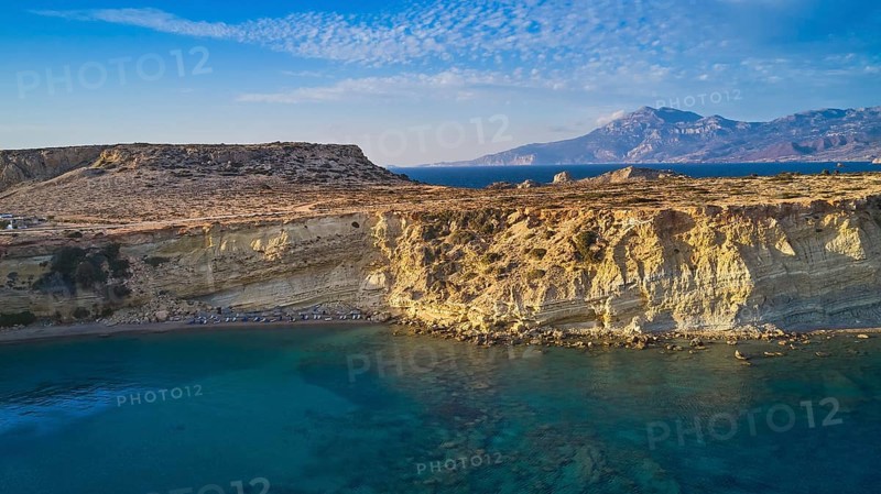 Rocky coast with bright sunshine and blue sky by the sea, drone shot, evening light, Paralia Agios Theodoros, Agios Theodoros Beach, southwest coast, Karpathos, Dodecanese, Greek Islands, Greece, Europe