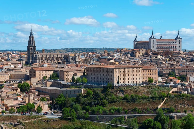 View of Toledo with historic buildings, a cathedral and trees under a blue sky, Cathedral, Cathedral of St Mary, Catedral de Santa Maria, Seminario Conciliar de San Ildefonso and Alcázar, Seminary, Alcazar, Toledo, Castilla-La Mancha, Spain, Europe