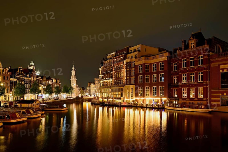 Historic buildings and mint tower illuminated at night, Singelgracht, Amsterdam, North Holland, Netherlands