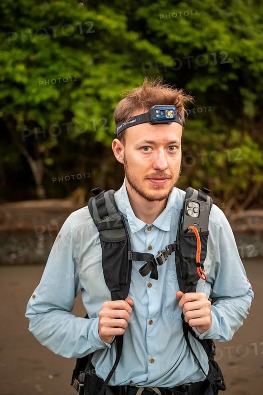 Tourist with headlamp and rucksack in the rainforest, Corcovado National Park, Osa Peninsula, Puntarena Province, Costa Rica, Central America