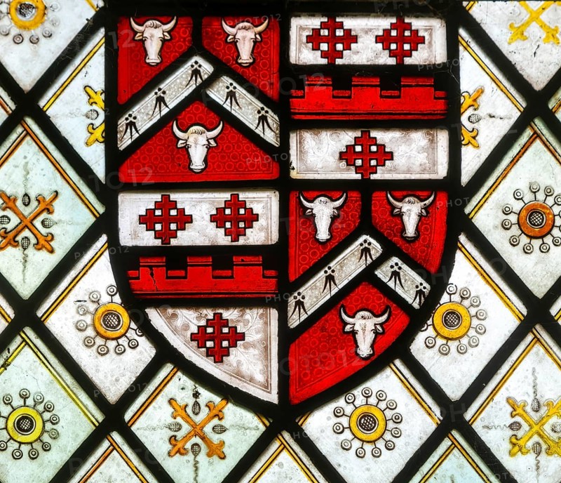 Detail of stained glass east window with heraldic design, church of All Saints, Rede, Suffolk, England, UK