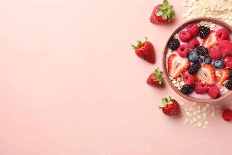 Top view of bowl with cereals and berry fruit mix on pink background with copy space. KI generiert, generiert, AI generated