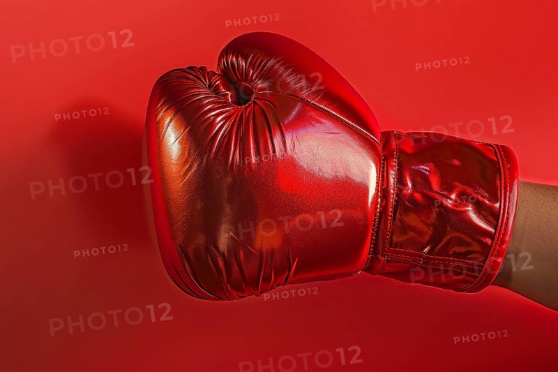 Bright red boxing glove on studio background. Generative AI, AI generated