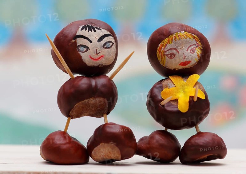 Two cute chestnut figures in front of a painted background, North Rhine-Westphalia, Germany, Europe