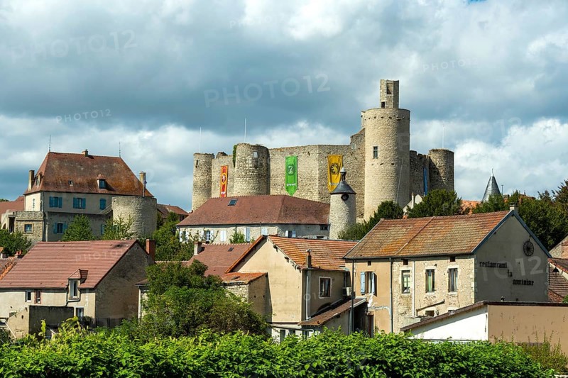 Billy. The fortress castle of the XIII Century, and its coloures banners, Allier. Auvergne-Rhone-Alpes.France