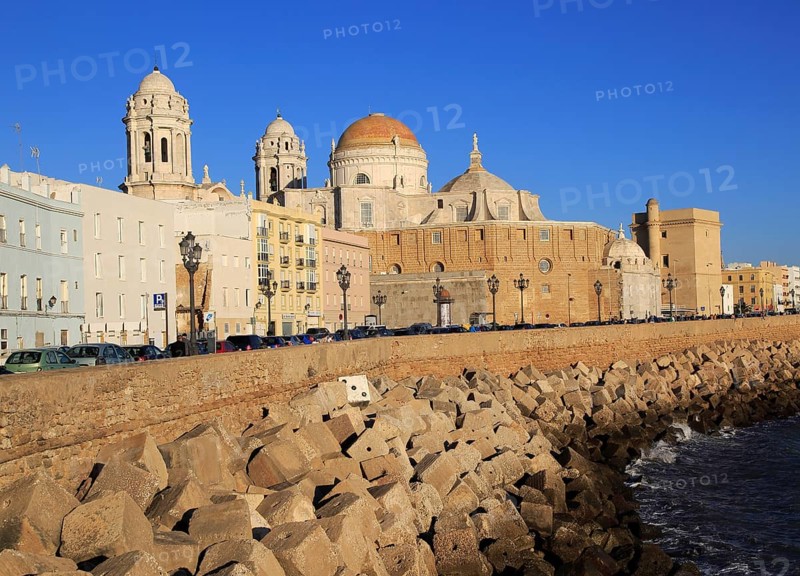 Coastal view east of rock armour coastal defences and cathedral, Cadiz, Spain, Europe
