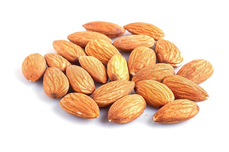 Pile of almonds isolated on white background. close up
