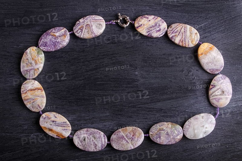Agate colored beads on a black background. top view, close up